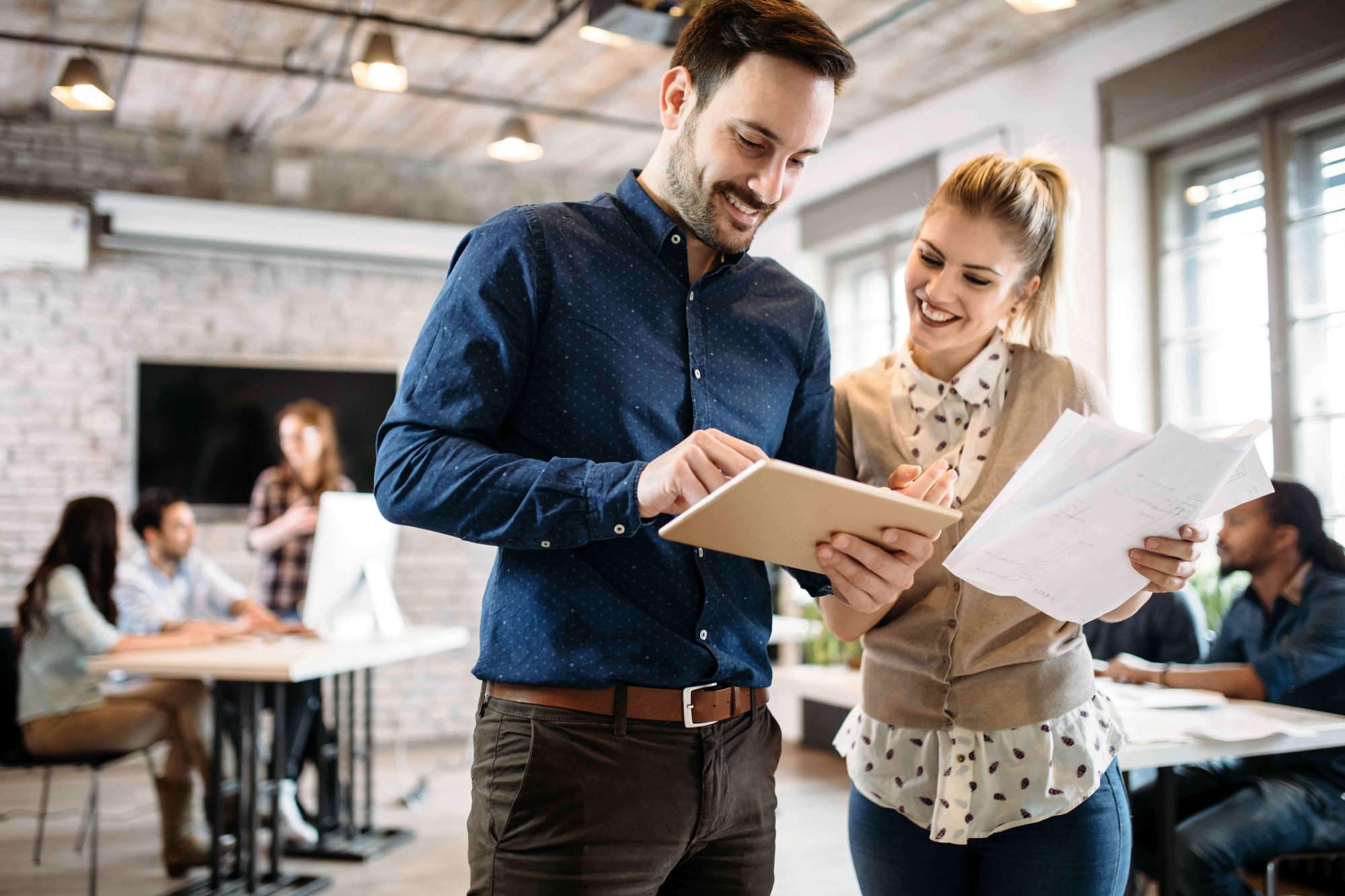 The image shows a business consulting session discussing IT services like firewall security consulting in an office environment.