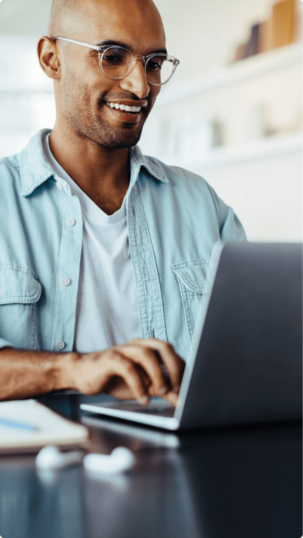 Man typing on a laptop keyboard