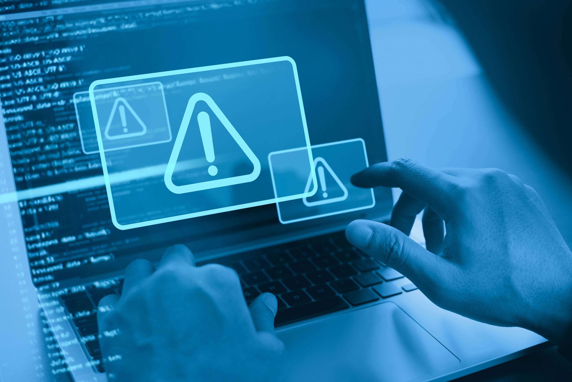 cyberthreaCyber security concept. Man using computer with system hacked alert due to cyber attack on computer network. Data Protection. Internet virus cyber security and cybercrime