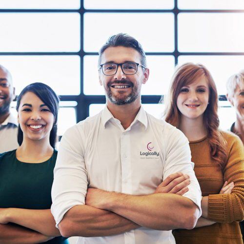 Portrait of a team of logically colleagues standing together with their arms crossed in a modern office